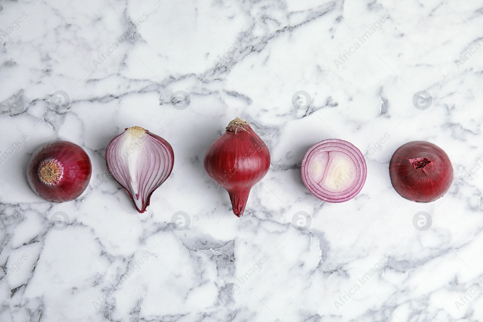 Photo of Beautiful composition with ripe red onions on marble background