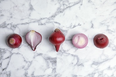 Beautiful composition with ripe red onions on marble background