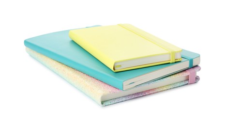 Photo of Stack of different colorful hardcover planners on white background