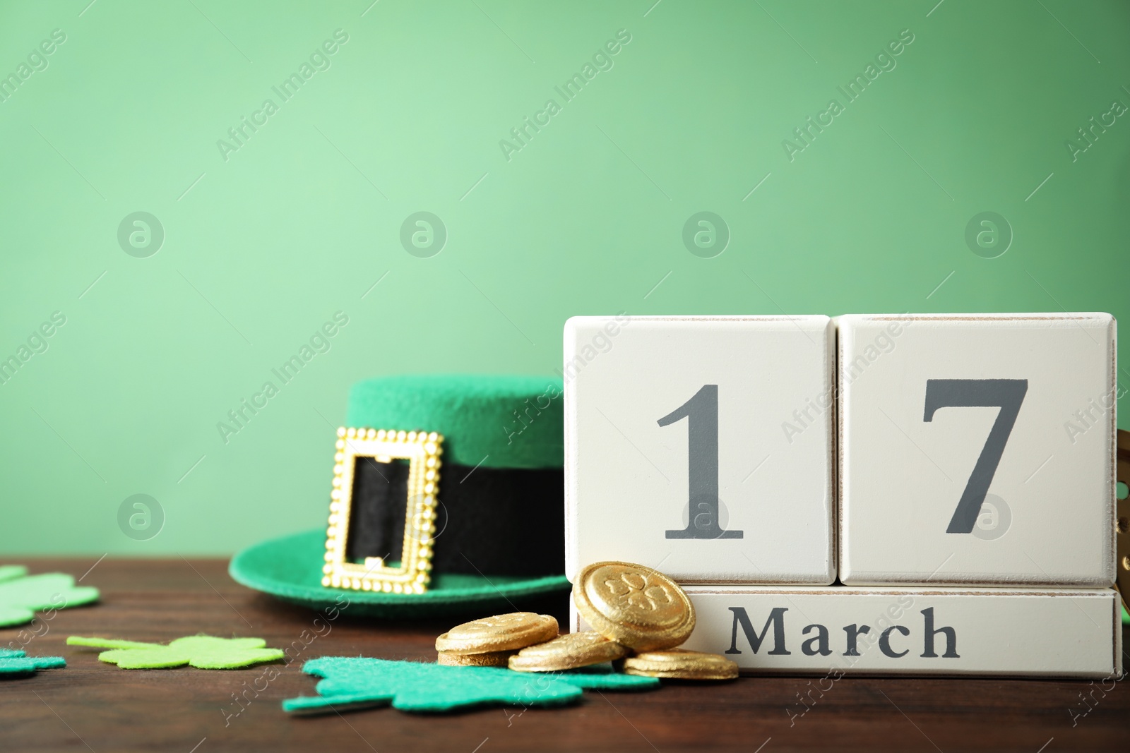 Photo of Composition with block calendar on wooden table, space for text. St. Patrick's Day celebration