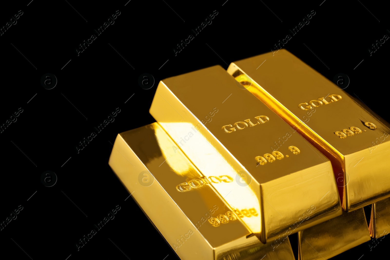 Photo of Stack of shiny gold bars on black background. Space for text