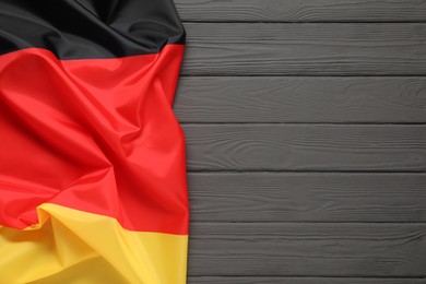 Flag of Germany on gray wooden background, top view. Space for text