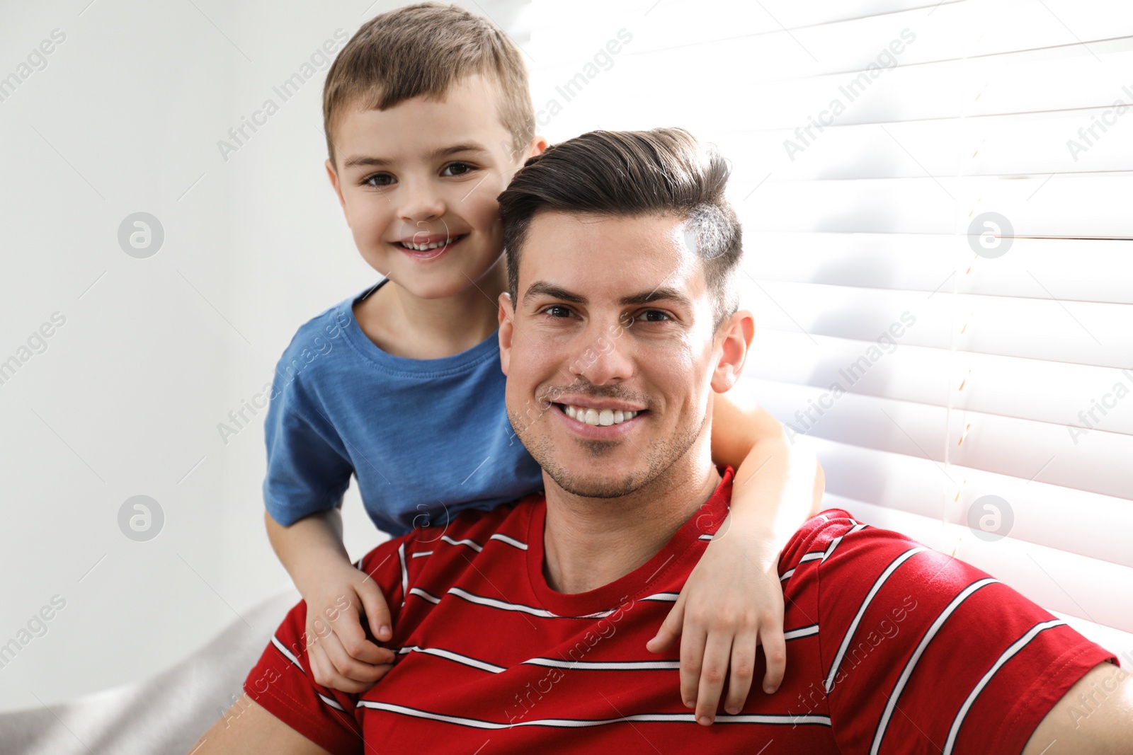 Photo of Dad and son spending time together at home. Happy Father's Day