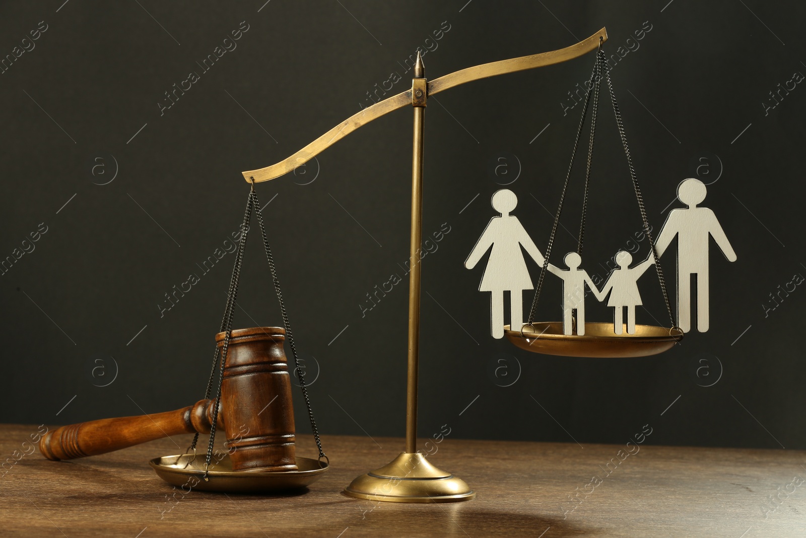 Photo of Divorce concept. Scales, paper cutout of family and gavel on wooden table