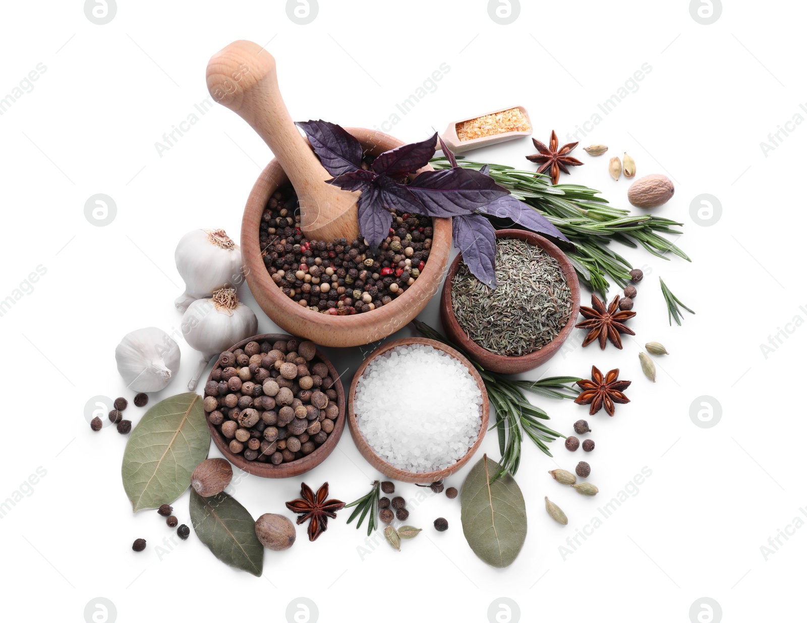 Photo of Mortar with pestle and different spices on white background, top view