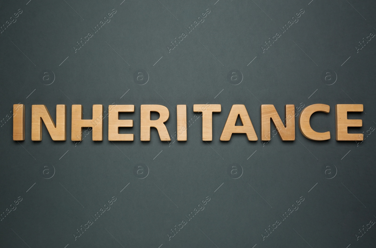 Photo of Word Inheritance made with wooden letters on black background, flat lay
