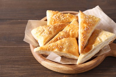 Photo of Delicious puff pastry on wooden table, closeup