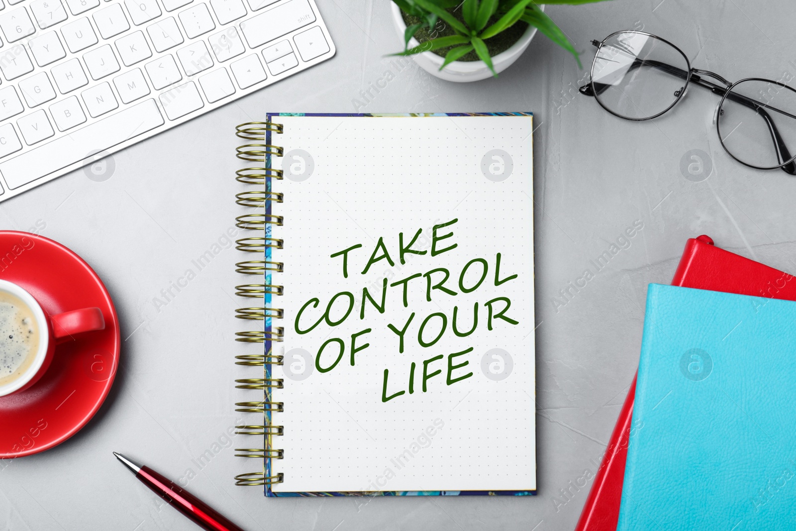 Image of Phrase Take Control of Your Life in notebook, office stationery and cup of coffee on light grey table, flat lay