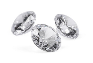 Photo of Three beautiful shiny diamonds isolated on white