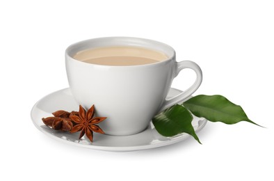 Photo of Cup of tea with milk, anise stars and green leaves on white background