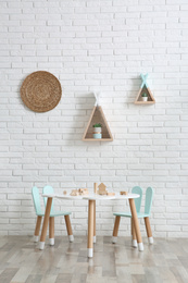 Photo of Cute children's room interior with little table