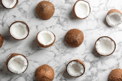 Photo of Coconut pattern on marble table, flat lay