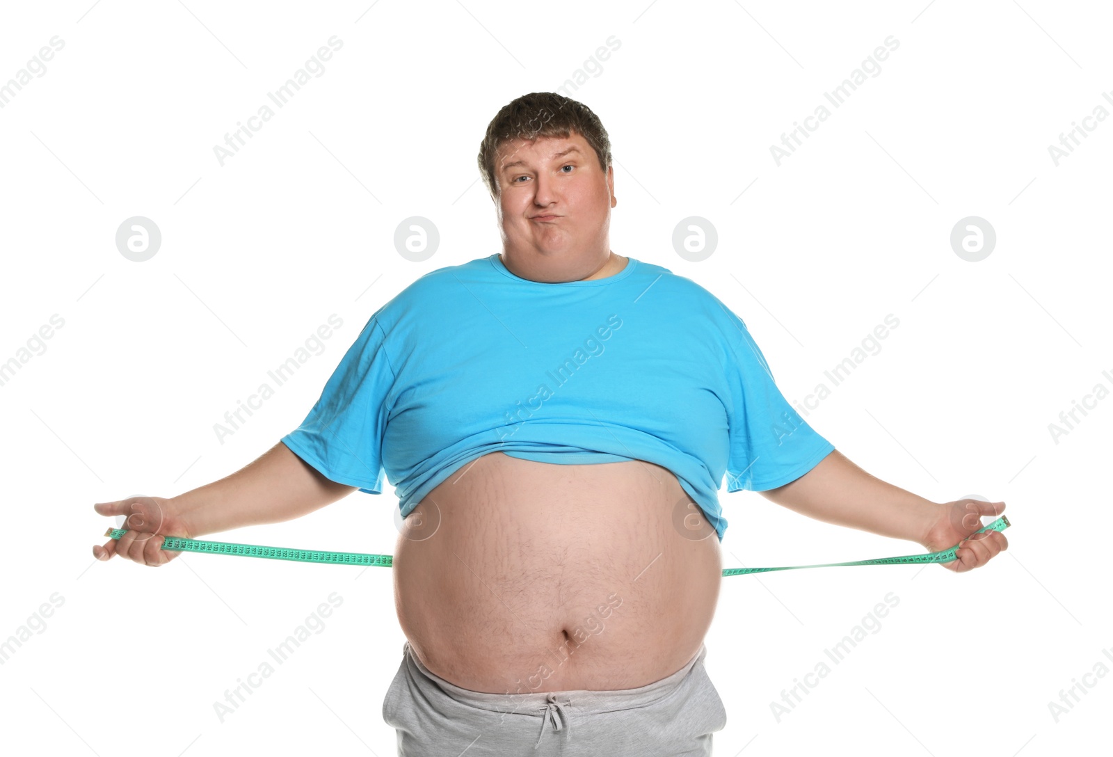Photo of Emotional overweight man with measuring tape on white background