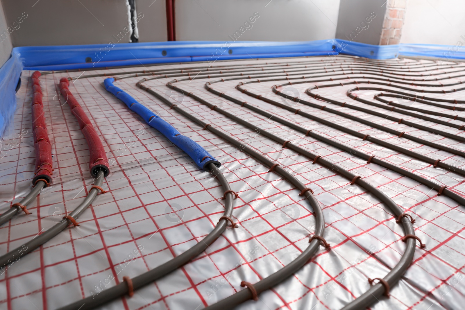 Photo of Installation of underfloor heating system in building