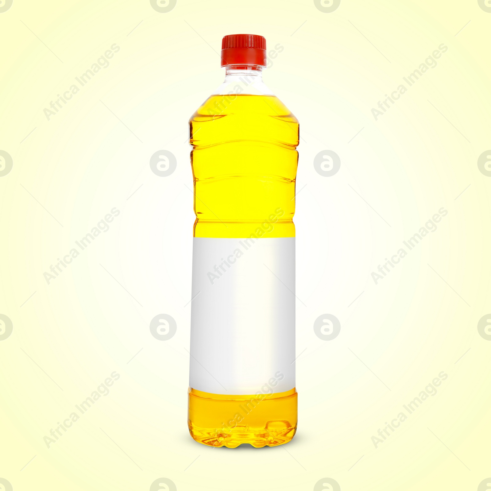 Image of Cooking oil in plastic bottle with empty label on light yellow background. Mockup for design