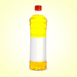 Image of Cooking oil in plastic bottle with empty label on light yellow background. Mockup for design