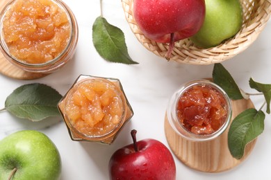Photo of Delicious apple jam and fresh fruits on white table, flat lay