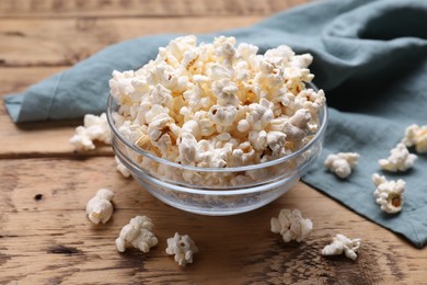 Tasty popcorn on wooden table, closeup view