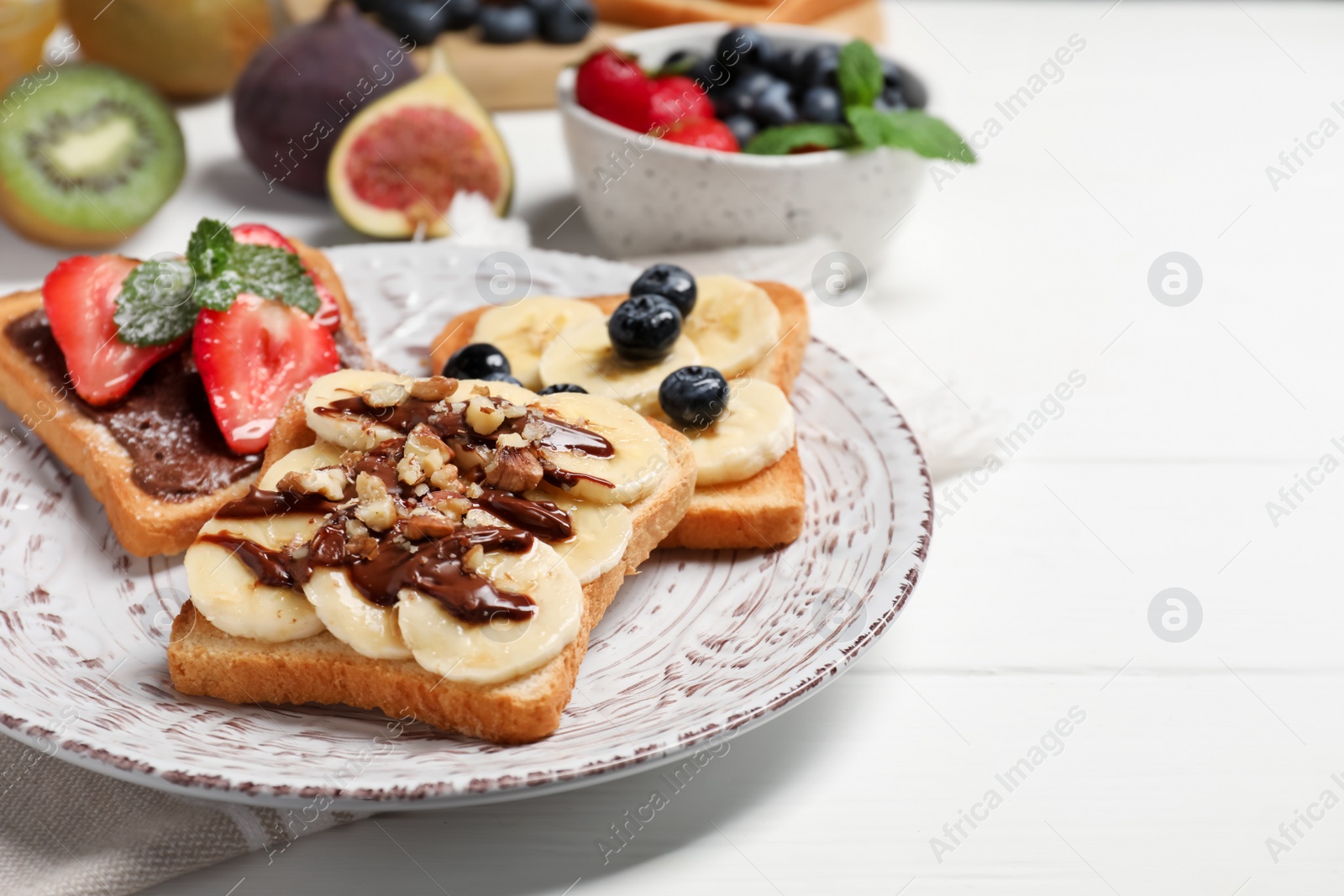 Photo of Different sweet delicious toasts on plate, closeup