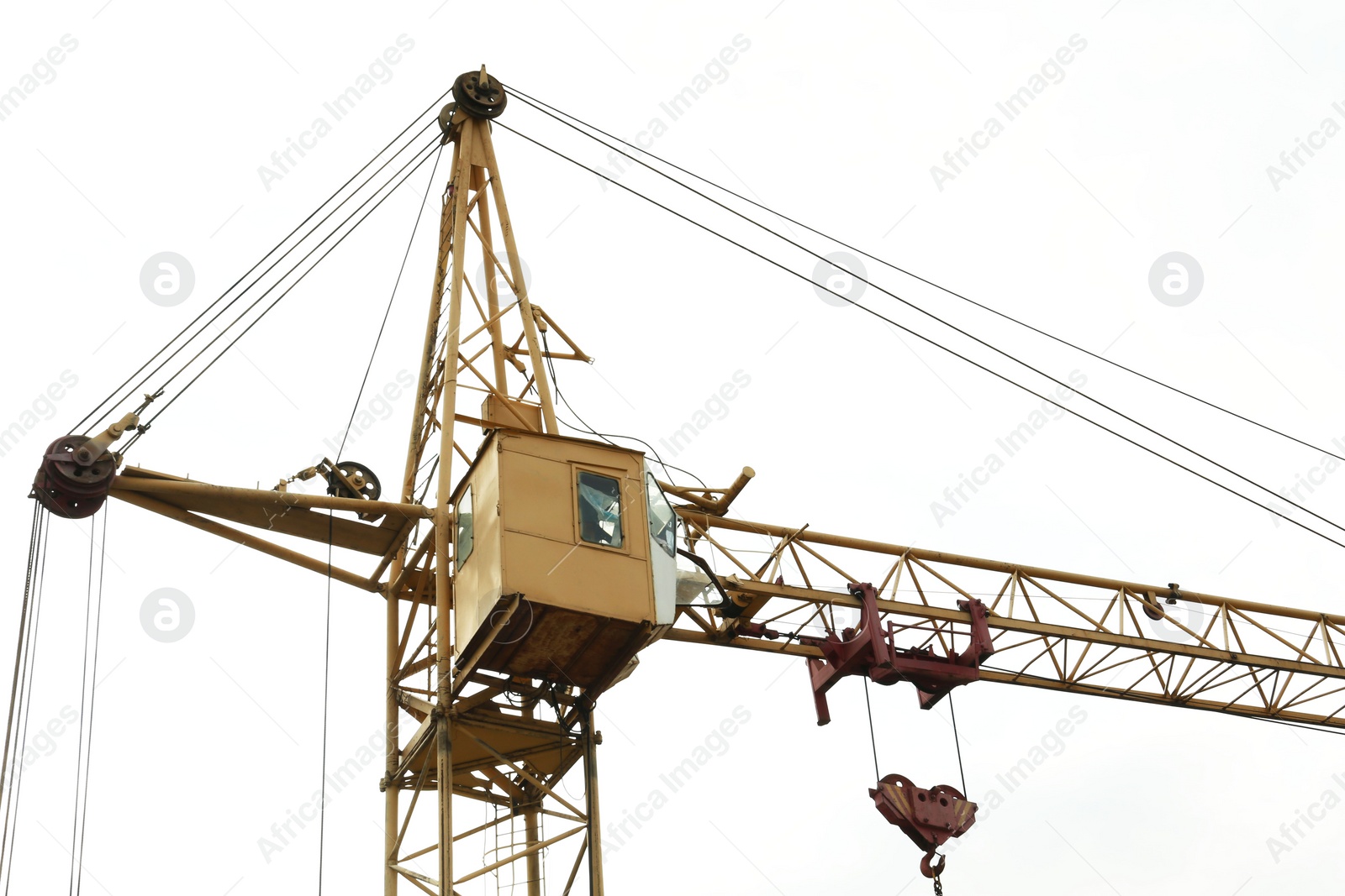 Photo of Tower crane under cloudy sky, low angle view. Construction site