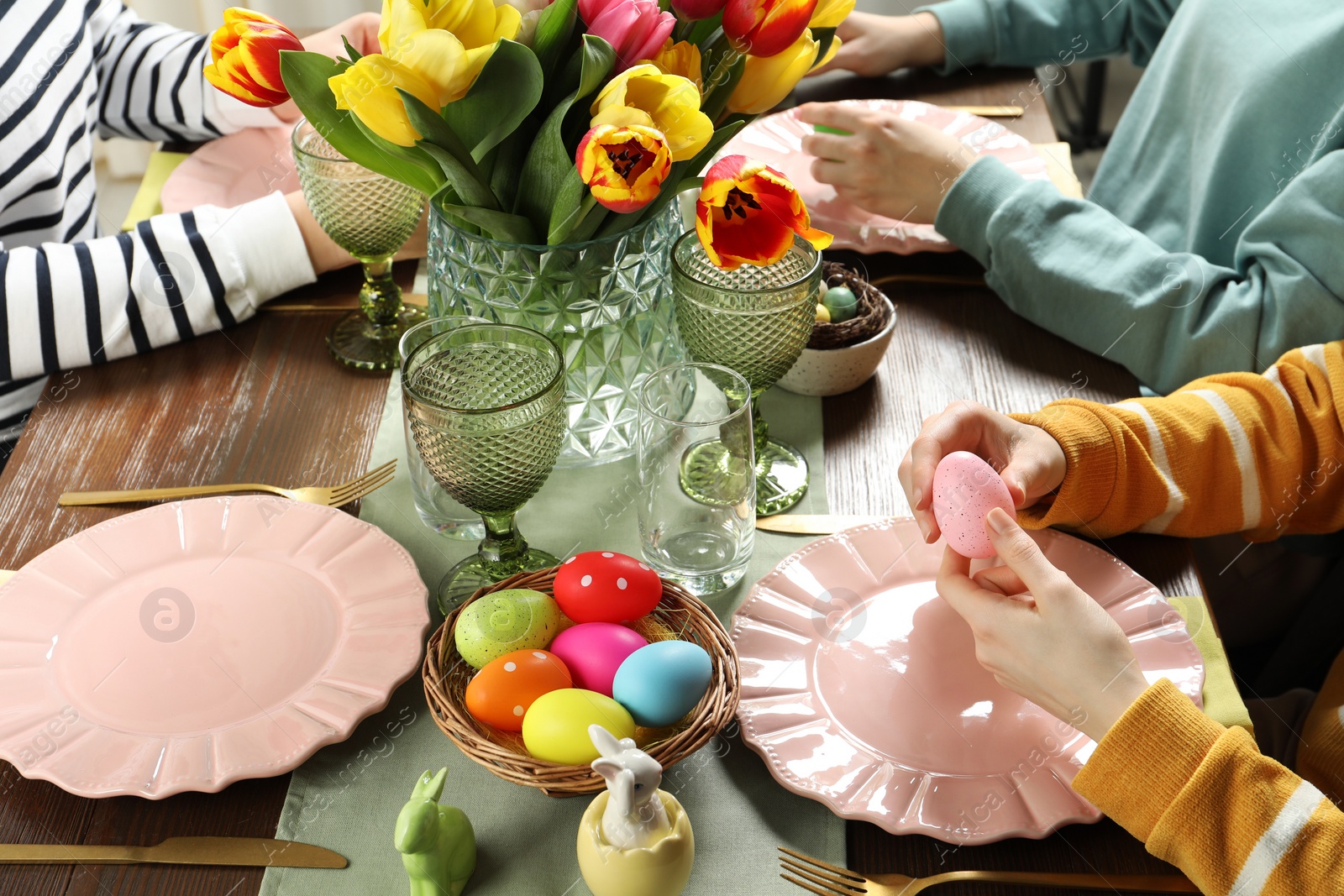 Photo of Festive table setting. Women celebrating Easter at home, closeup