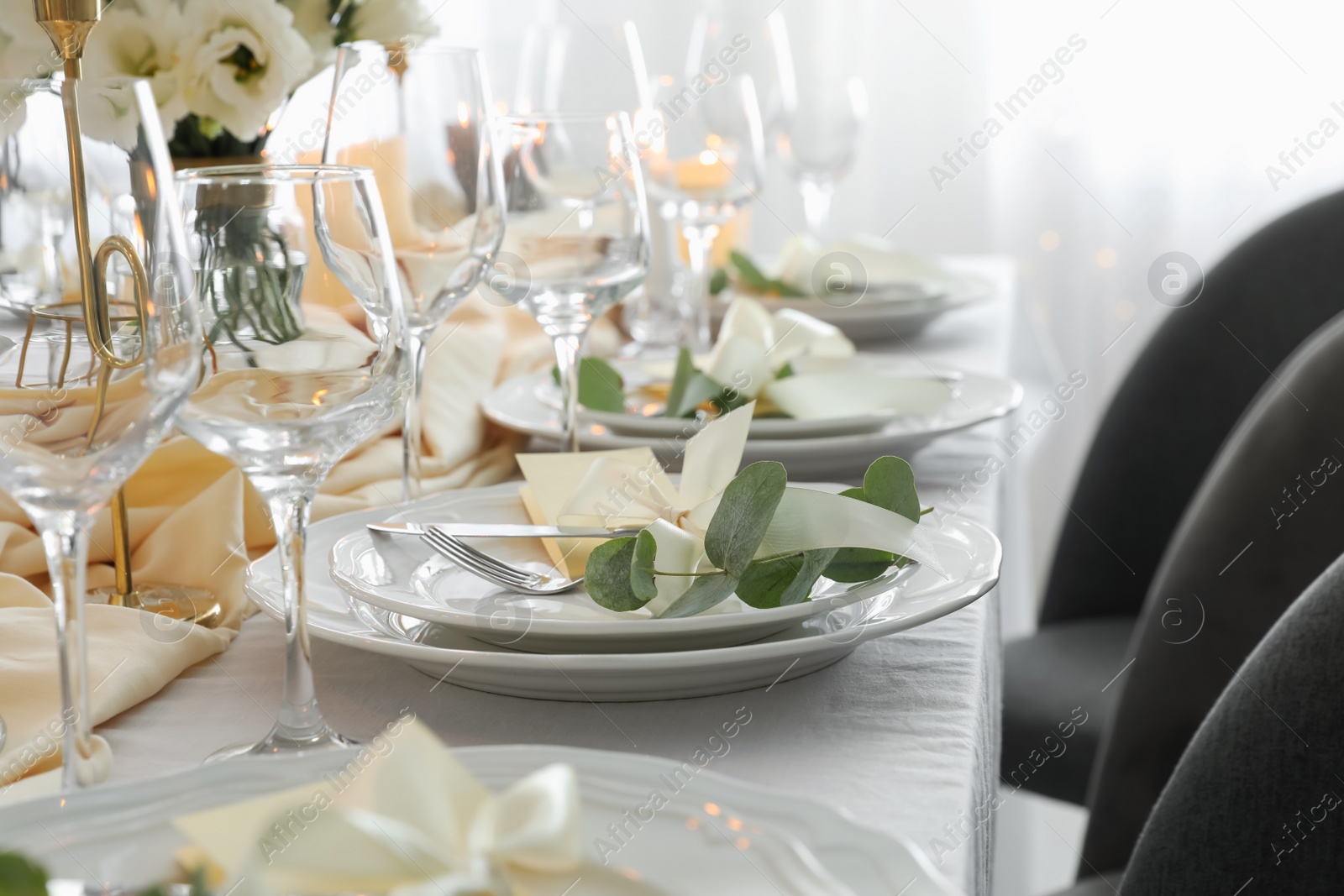 Photo of Festive table setting with beautiful floral decor in restaurant