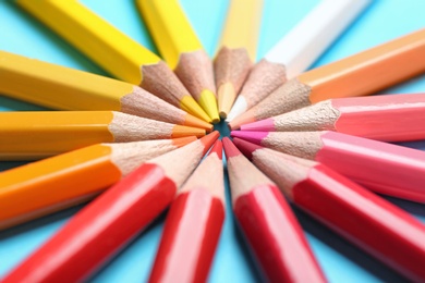 Photo of Composition with colorful pencils on light blue background, closeup