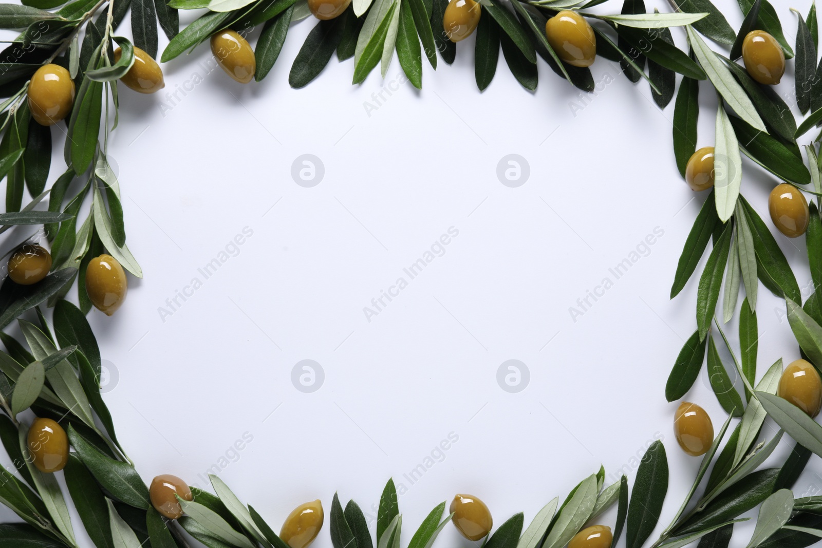 Photo of Frame made of fresh green olives and leaves on white background, flat lay. Space for text