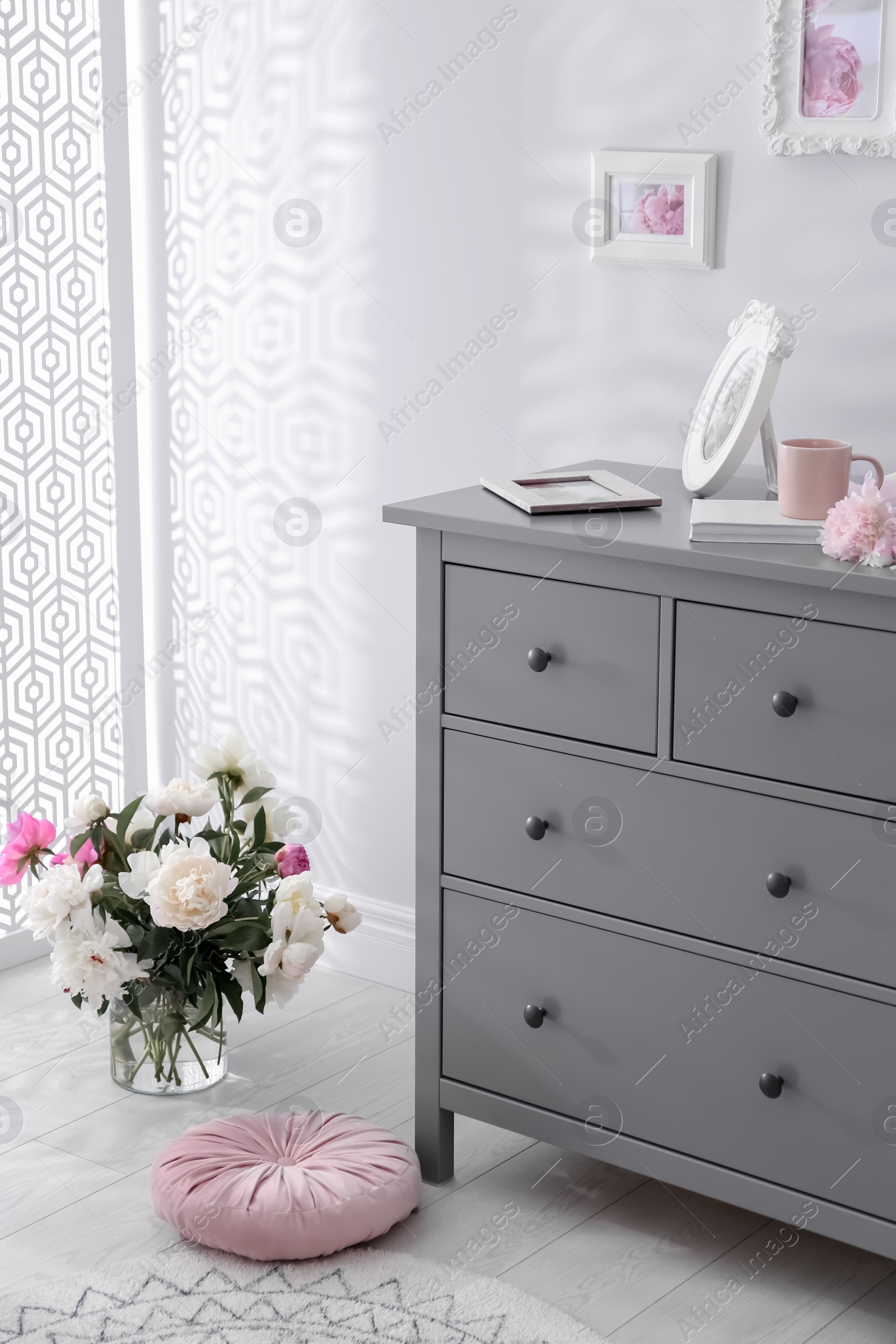 Photo of Grey chest of drawers in stylish room interior