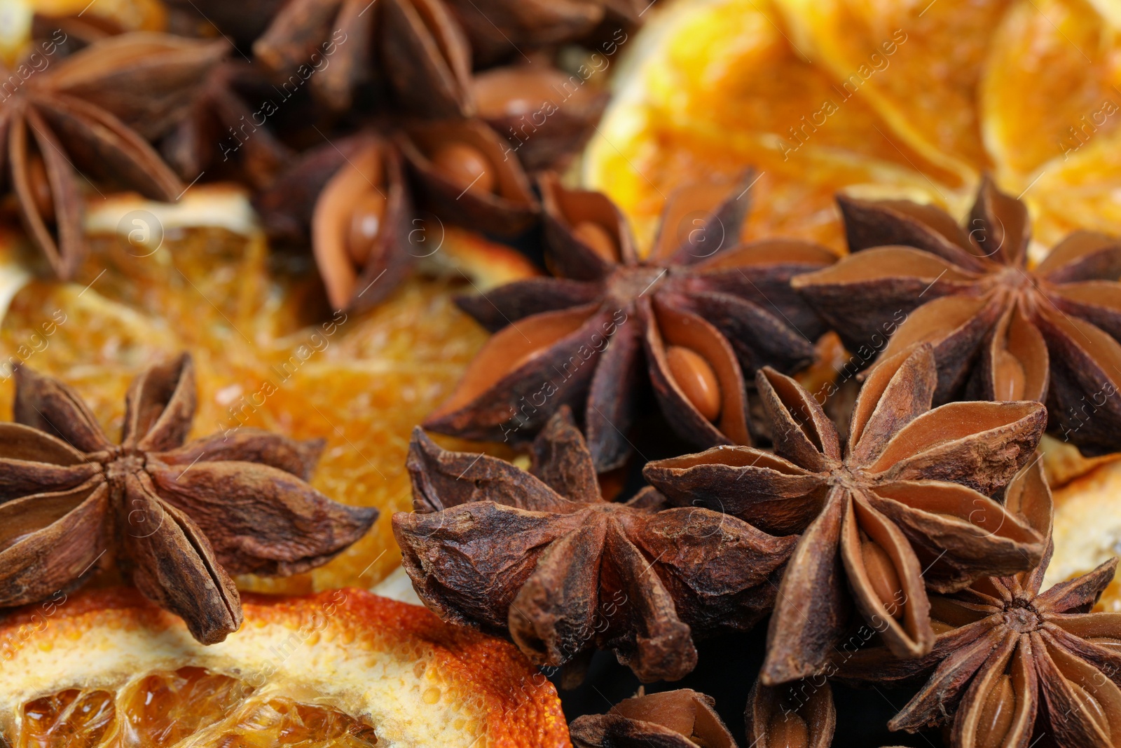 Photo of Dry orange slices and anise stars as background, closeup