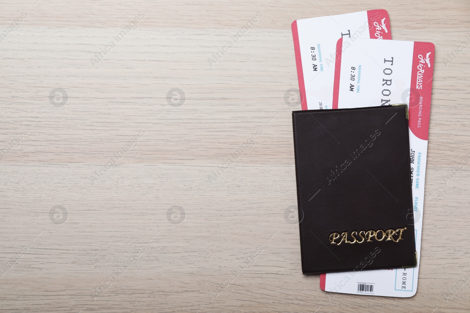 Photo of Avia tickets and passport on wooden table, flat lay with space for text. Travel agency concept