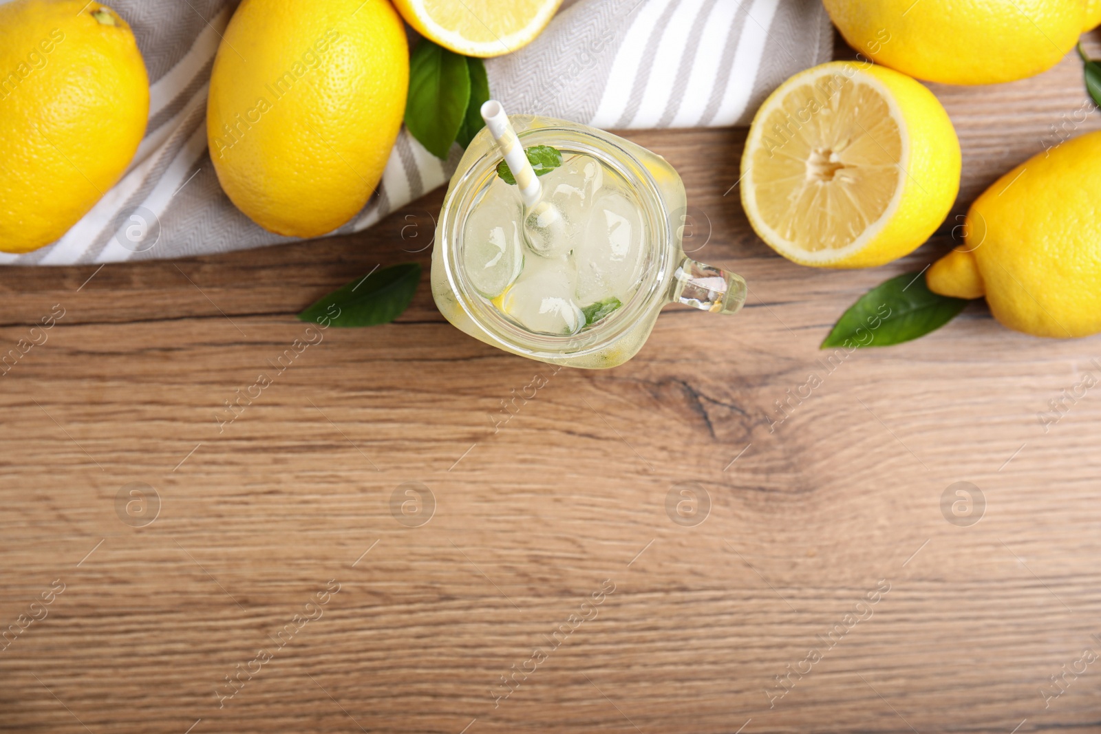 Photo of Cool freshly made lemonade and fruits on wooden table, flat lay. Space for text