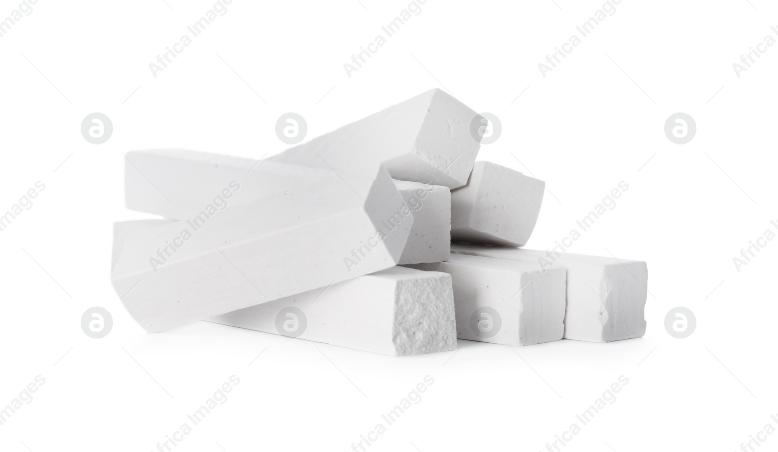 Photo of Small pieces of chalk on white background