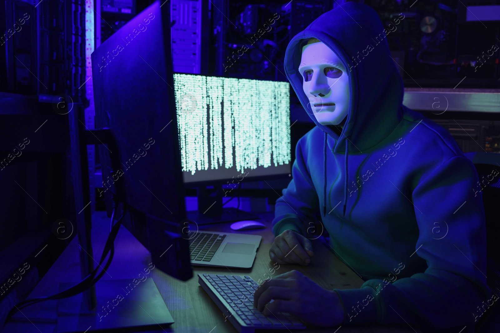 Photo of Hacker working with computers in dark room. Cyber attack