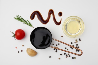 Organic balsamic vinegar and cooking ingredients on white background, flat lay