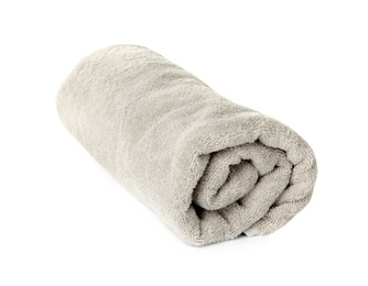 Photo of Rolled clean beige towel on white background