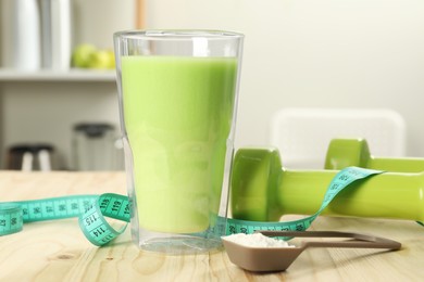 Photo of Tasty shake, dumbbells, measuring tape and powder on wooden table indoors, closeup. Weight loss