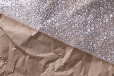 Transparent bubble wrap on kraft paper, top view. Space for text