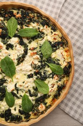 Photo of Delicious homemade spinach quiche on table, top view