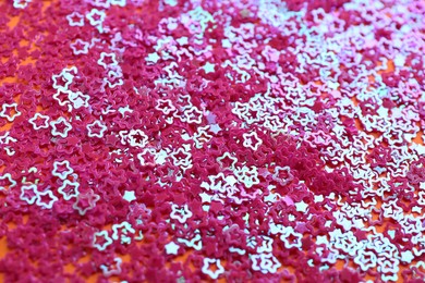 Photo of Shiny bright pink glitter as background, closeup