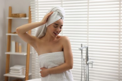 Photo of Smiling woman after shower in bathroom. Space for text