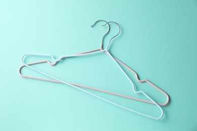 Two hangers on light blue background, top view