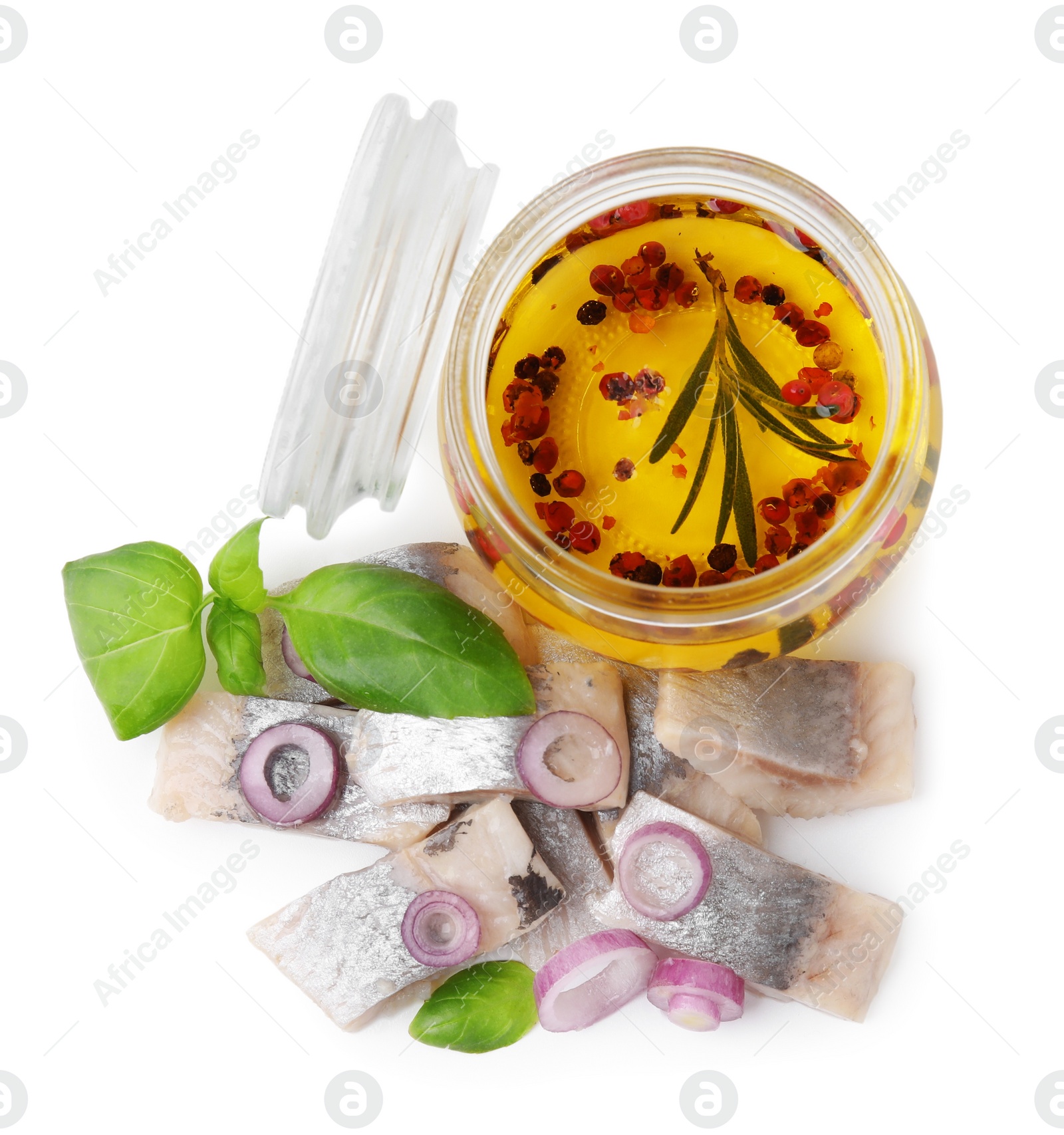 Photo of Pieces of tasty fish, onion, basil and marinade isolated on white, top view
