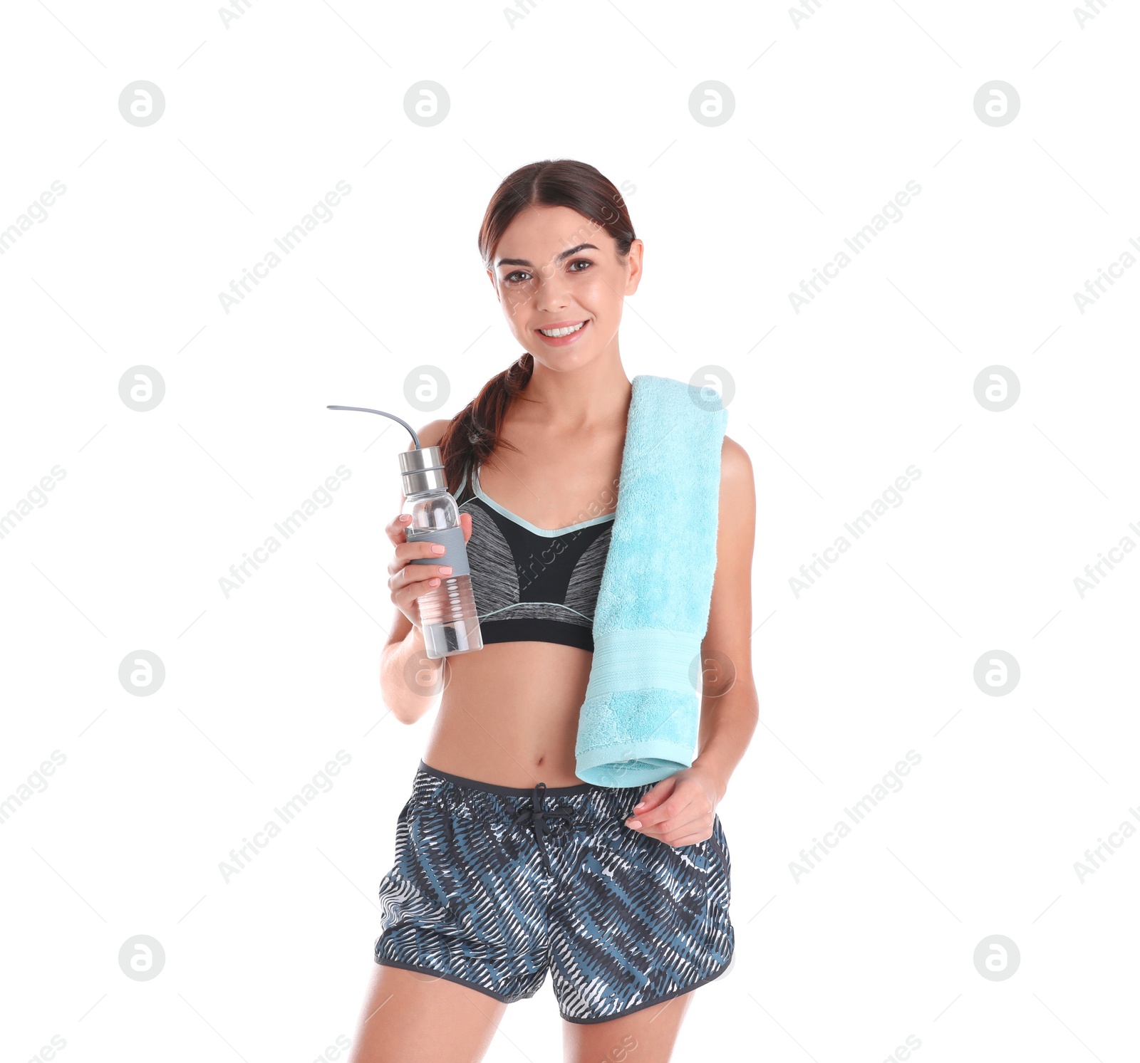 Photo of Beautiful young woman in sportswear with towel and bottle of water on white background