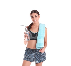 Beautiful young woman in sportswear with towel and bottle of water on white background