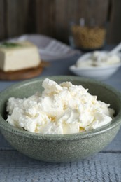 Delicious tofu cream cheese in bowl on grey wooden table