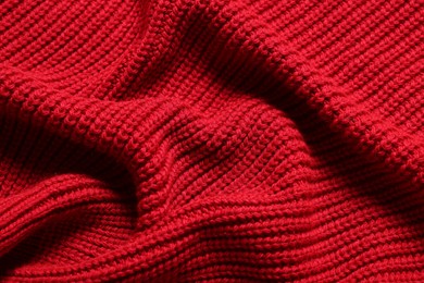 Photo of Texture of soft red knitted fabric as background, top view