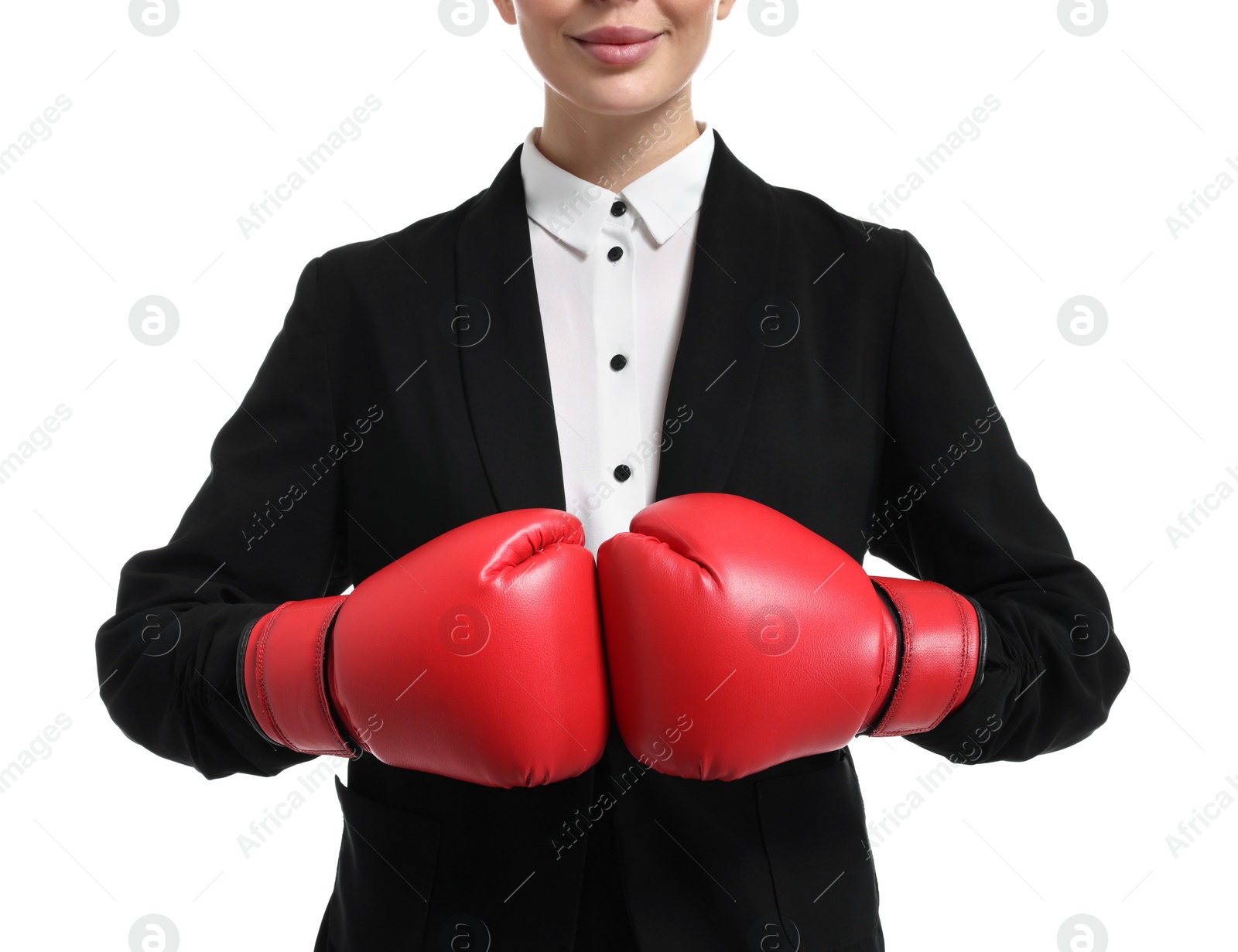 Photo of Businesswoman in suit wearing boxing gloves on white background, closeup