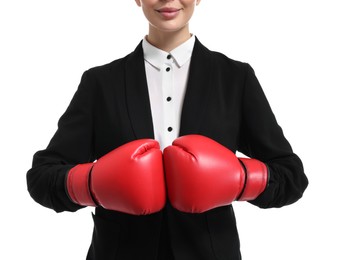 Businesswoman in suit wearing boxing gloves on white background, closeup