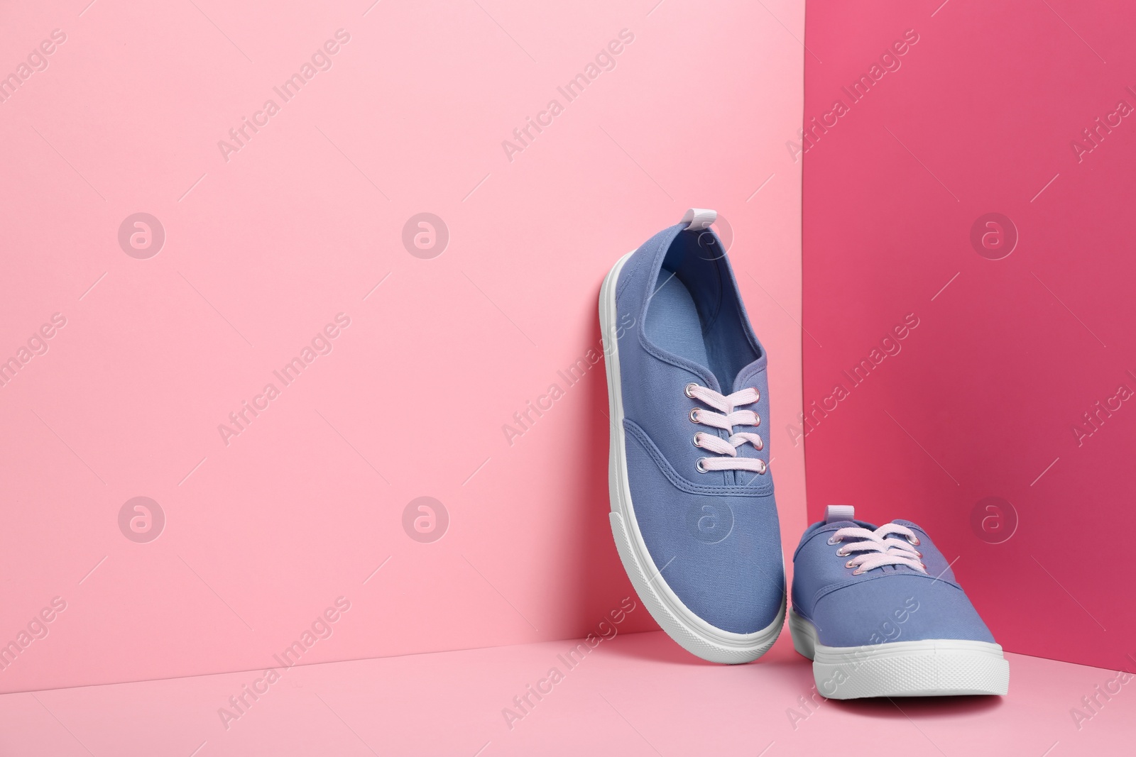 Photo of Comfortable sneakers on color background, space for text